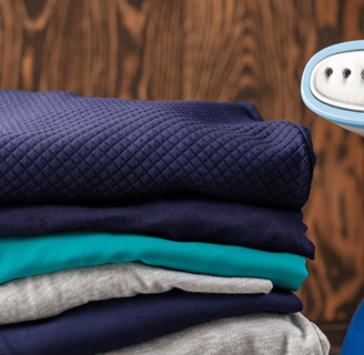 a pile of folded folded towels and a blue and white electric razor razor razor razor