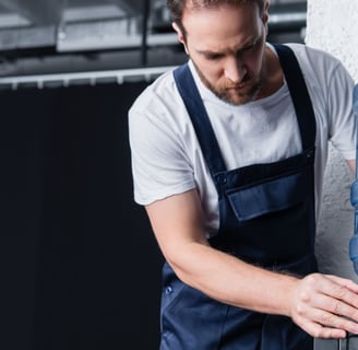 a man in overalls and overalls, a water bottle and a water di