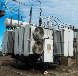a large group of electrical equipment sitting on top of a field