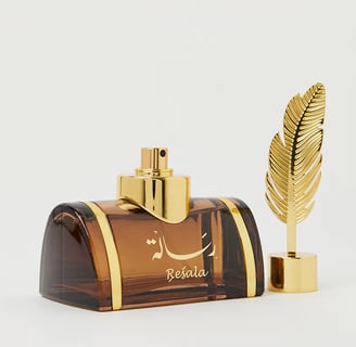 a perfume bottle with a feather feather feather feather