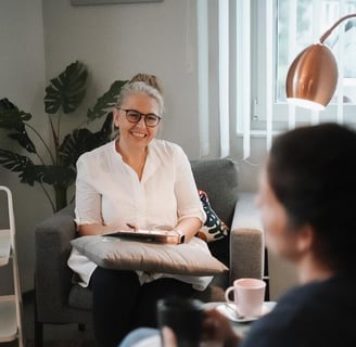 a woman sitting on a couch in a living room