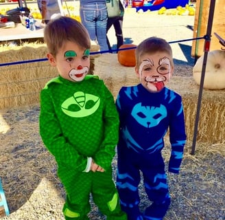 A Puppy and Clown Face Painting at a Pumpkin Patch