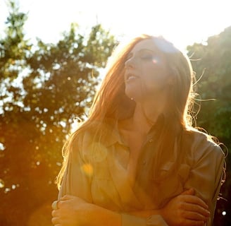 Layla Claire close-up portrait in golden sun light, artist branding shoot