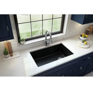 a kitchen sink with a sink and a bowl of fruit