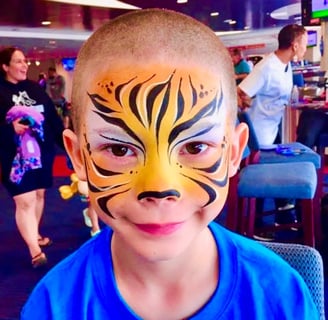 Boy Tiger Face Painting at a Large Event