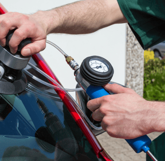 a man is holding a hose and a hose in his hand