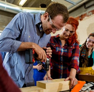 people working with wood in the makerspace