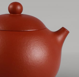 Tiny spots scattered across the teapot visible under bright light