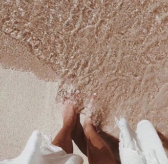 a brides footsteps in sand