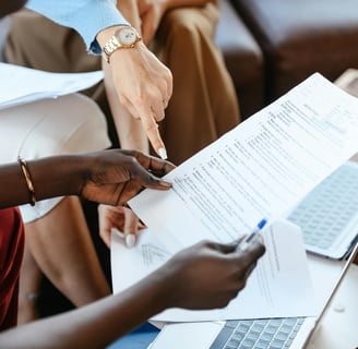 a person holding a piece of paper with a person holding a pen