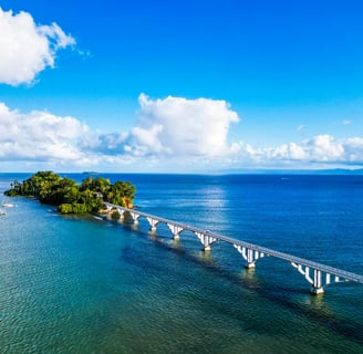 Samaná bridge over blue ocean with sailboats and tropical island in Dominican Republic