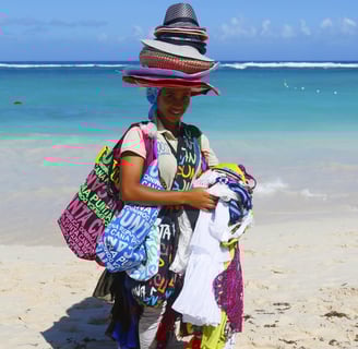 Beach vendor selling hats and souvenirs in Punta Cana, Dominican Republic with ocean background