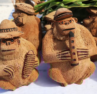 Handcrafted coconut shell monkey souvenirs playing instruments in the Dominican Republic