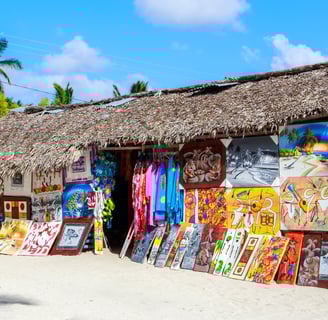 Colorful Dominican paintings displayed at a beach art and souvenir shop in the Dominican Republic