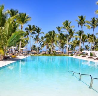 a pool with a swimming pool and lounge chairs