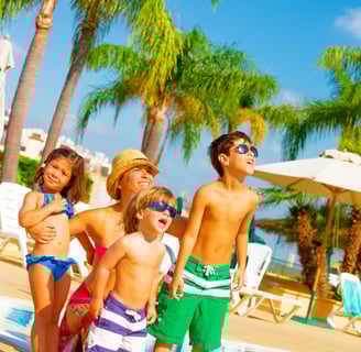 a family standing around a pool in punta cana