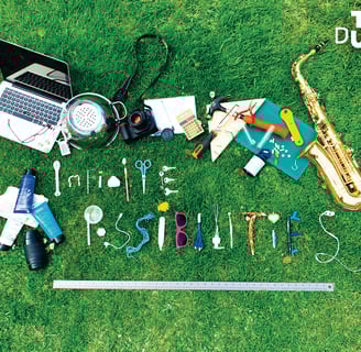 Image og household/hobbies items spelling out Infinite Possibilities on grass