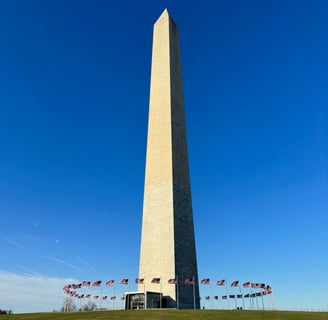 The Washington monument, an obelisk, in front of a blue sky