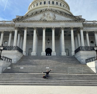 The United States capital building with a lady in front