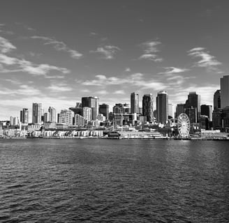 a black and white Seattle city seen from the water