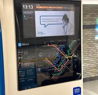 A digital screen on the Montreal Metro showing the system map and current location