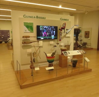 a museum display showing instruments from guinea-bissau and guinea