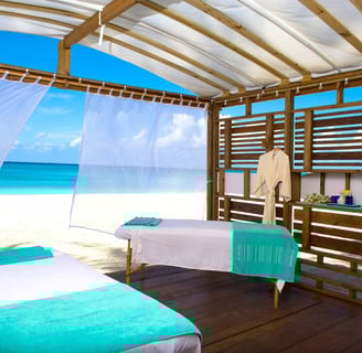 a couple of beds in a room with a view of the ocean from The Westin Grand Cayman hotel