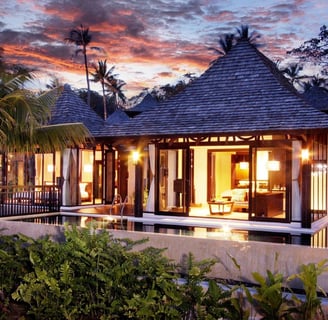 a house with a pool and a view of the ocean from The Vijitt Resort Phuket