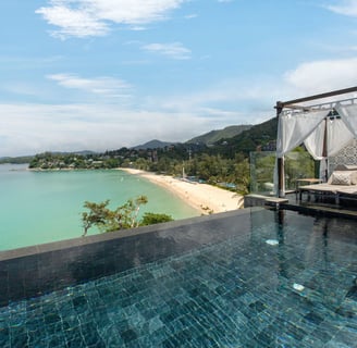 a bed with a canopy bed and a canopy bed from The Shore at Katathani, Phuket Thailand