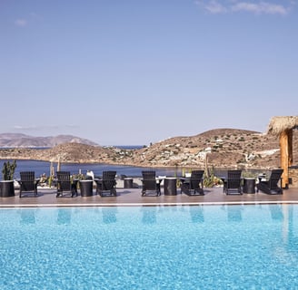 a pool with chairs and chairs around it Liostasi Hotel