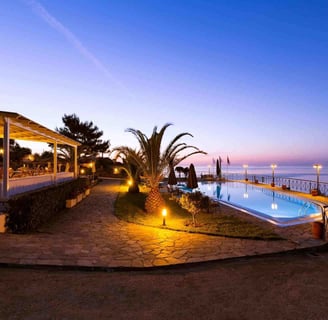 a pool with a view of the ocean Karra's Star Hotel