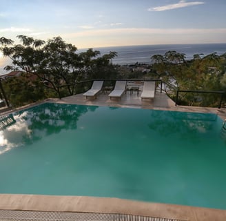 a pool with a view of the ocean Pyrgos Traditional Village