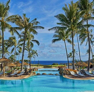 a pool with lounge chairs and umbrellas from The Ritz-Carlton, Kapalua in Hawaii