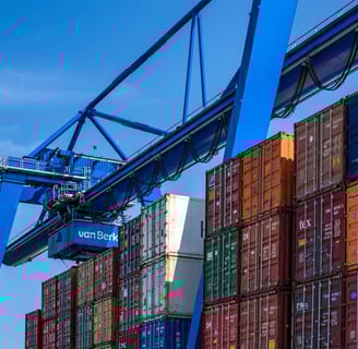 a crane is lifting a container at a container yard
