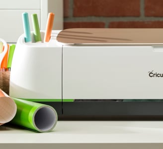 a cricut machine with a printer and some pens