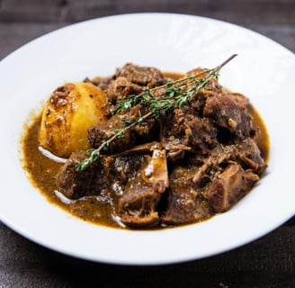 a plate of food with meat and potatoes
