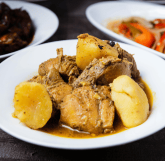 a plate of food with chicken and potatoes