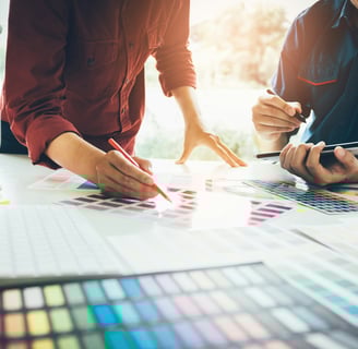 Graphic designers working on choosing colors for marketing materials