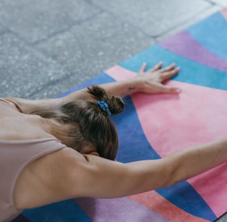 a woman is doing yoga exercises on a colorful mat