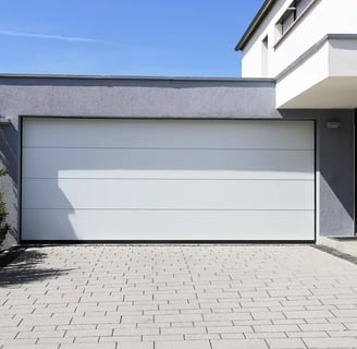 a garage door with a white garage door and a brick wall