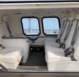 Luxurious VIP interior of AW109 Grand helicopter with premium seating and advanced features.