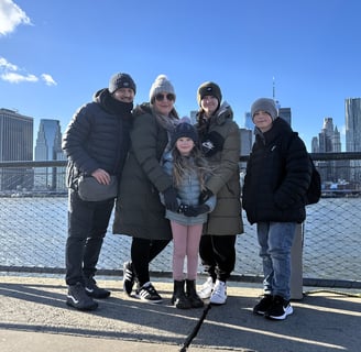 A family portrait of Ben, Claire, Lilie, Drew & Poppy Walker against the backdrop of New York taken in Brooklyn