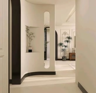 a hallway with a white wall and a black door