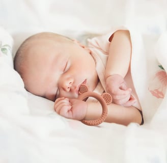 baby with teething ring