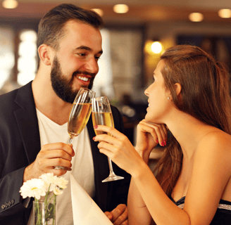 a man and woman are drinking champagne flutes