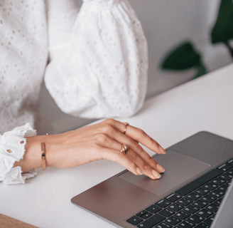 Close-up of woman typing on a laptop, seeking fertility information online