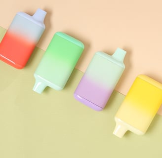 Colorful pastel disposable vapes laid out on a soft color-blocked background.
