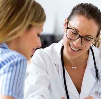 Female doctor warmly explaining fertility results to a patient
