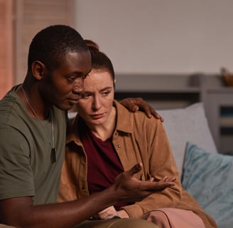 Worried couple speaking about fertility together on the couch