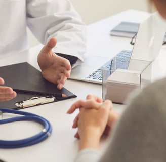 Fertility doctor explaining IVF process to patient during a clinic visit